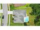 Aerial view of a well-kept home with a pool, lush landscaping, and a spacious driveway at 3909 Corveta Ct, Orlando, FL 32837