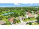 An aerial view showcasing the neighborhood, with lush green spaces, community tennis courts, and serene lake views at 3909 Corveta Ct, Orlando, FL 32837