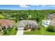 An aerial view of a well-maintained property featuring lush landscaping and a charming front facade at 3909 Corveta Ct, Orlando, FL 32837
