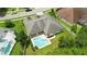 Aerial view of a beautifully landscaped property with a pool, covered patio, and mature trees at 3909 Corveta Ct, Orlando, FL 32837