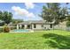 Well-maintained backyard featuring a pool, covered patio, and a spacious lawn for outdoor activities at 3909 Corveta Ct, Orlando, FL 32837