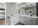 Bright bathroom featuring double vanity with white countertops and gray cabinets at 3909 Corveta Ct, Orlando, FL 32837