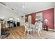 Dining area featuring a glass-top table, white chairs, and views of the office area and kitchen at 3909 Corveta Ct, Orlando, FL 32837
