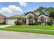Beautiful single-story home featuring a well-kept lawn and attached two-car garage at 3909 Corveta Ct, Orlando, FL 32837