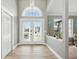 Elegant foyer with decorative front doors, high ceilings, and luxury vinyl flooring at 3909 Corveta Ct, Orlando, FL 32837