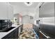 Modern kitchen with dark cabinets, light countertops, stainless steel appliances, and a view to the dining room at 3909 Corveta Ct, Orlando, FL 32837