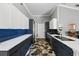 Open kitchen with white quartz countertops, dark cabinetry, and geometric-patterned tile flooring at 3909 Corveta Ct, Orlando, FL 32837