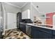 Open kitchen with dark cabinetry and geometric-patterned tile flooring, complete with modern appliances at 3909 Corveta Ct, Orlando, FL 32837