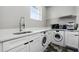 Laundry room with white washer and dryer, sink and countertop at 3909 Corveta Ct, Orlando, FL 32837
