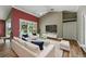 Bright living room with vaulted ceilings, modern furniture, and large windows overlooking the outdoor pool at 3909 Corveta Ct, Orlando, FL 32837
