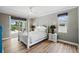 Bright main bedroom with a four-poster bed, modern lamps, and sliding door access to the pool area at 3909 Corveta Ct, Orlando, FL 32837