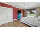 Bright main bedroom with pool view, ensuite access, wood floors, and closet at 3909 Corveta Ct, Orlando, FL 32837
