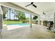 Relaxing covered patio area with ceiling fans, overlooking a refreshing pool and landscaped backyard at 3909 Corveta Ct, Orlando, FL 32837
