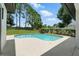 Beautiful backyard pool surrounded by lush landscaping and a well-maintained lawn at 3909 Corveta Ct, Orlando, FL 32837