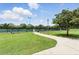 Community tennis courts and a paved walkway under a blue sky with fluffy clouds at 3909 Corveta Ct, Orlando, FL 32837