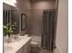Beautifully designed bathroom featuring a double vanity, tiled walls, and a shower-tub combination at 742 Copper Creek Dr, New Smyrna Beach, FL 32168