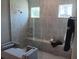 Modern bathroom featuring a walk-in shower, tiled walls, and a comfortable seating area at 742 Copper Creek Dr, New Smyrna Beach, FL 32168
