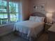 Cozy bedroom with large windows, plush carpeting, and ample natural light at 742 Copper Creek Dr, New Smyrna Beach, FL 32168
