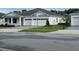 Charming single-story home featuring a three-car garage, manicured lawn and meticulous landscaping at 742 Copper Creek Dr, New Smyrna Beach, FL 32168