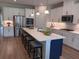 Modern kitchen features a large island, stainless steel appliances, and white cabinets at 742 Copper Creek Dr, New Smyrna Beach, FL 32168