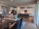 Elegant open-concept living space with hardwood flooring, a modern kitchen and stylish decor at 742 Copper Creek Dr, New Smyrna Beach, FL 32168
