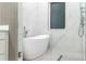 Modern bathroom with a freestanding tub, white marble tile, glass shower, and sleek chrome fixtures at 1841 Moorings Ct, Clermont, FL 34711