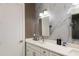 Elegant bathroom with marble-patterned walls, a double vanity, and stylish lighting fixtures at 1841 Moorings Ct, Clermont, FL 34711