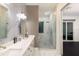 Luxurious bathroom showcasing double sinks, marble accents, and a glass-enclosed shower at 1841 Moorings Ct, Clermont, FL 34711