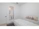 Cozy bedroom featuring ensuite bathroom, white walls, and comfortable bed with decorative pillows at 1841 Moorings Ct, Clermont, FL 34711