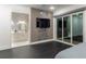 Modern bedroom with a sleek accent wall and sliding glass doors offering natural light at 1841 Moorings Ct, Clermont, FL 34711