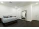 Well-lit bedroom featuring dark wood floors, a bed with plush pillows, and a decorative mirror at 1841 Moorings Ct, Clermont, FL 34711
