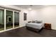 Comfortable bedroom with dark wood floors, stylish furnishings, and a sliding glass door at 1841 Moorings Ct, Clermont, FL 34711