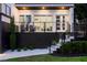 Outdoor patio with chairs and spiral staircase that leads to upper floors and manicured garden at 1841 Moorings Ct, Clermont, FL 34711