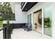 View of upper level patio with spiral staircase access featuring seating and sliding glass door to the interior at 1841 Moorings Ct, Clermont, FL 34711