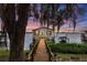 Charming lake house with a dock and boat, surrounded by lush foliage and serene water views at 1841 Moorings Ct, Clermont, FL 34711