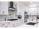Modern kitchen featuring white cabinets, marble countertops, and stainless steel appliances at 1841 Moorings Ct, Clermont, FL 34711