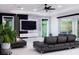 Contemporary living room featuring sleek sofas, a marble accent wall, and backyard views at 1841 Moorings Ct, Clermont, FL 34711