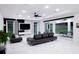 Spacious living room with modern furnishings and access to the outdoor patio at 1841 Moorings Ct, Clermont, FL 34711