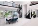 Bright, open-concept living space with a spiral staircase and large windows at 1841 Moorings Ct, Clermont, FL 34711