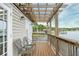Enjoy serene lake views from this covered patio with comfortable seating area at 1841 Moorings Ct, Clermont, FL 34711