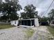 Charming home featuring a screened porch and a spacious gravel driveway at 721 Crestview Dr, Casselberry, FL 32707