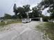 View of front exterior featuring gravel driveway and white exterior at 721 Crestview Dr, Casselberry, FL 32707