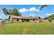 Expansive backyard showcasing a brick home with a well-maintained lawn at 4120 Chelsea Ln, Lakeland, FL 33809