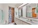 Bathroom featuring double sinks with vanity and a walk-in shower with grab bar at 4120 Chelsea Ln, Lakeland, FL 33809