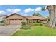 Inviting single-story home with an attached garage and manicured lawn at 4120 Chelsea Ln, Lakeland, FL 33809