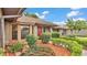 Charming single Gathering home with a well-manicured lawn, beautiful landscaping, and a red front door at 4120 Chelsea Ln, Lakeland, FL 33809