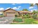 Charming single Gathering home with a well-manicured lawn, beautiful landscaping, and a two car garage at 4120 Chelsea Ln, Lakeland, FL 33809