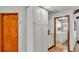 Hallway with wood floors leading to laundry room and features large white cabinets for ample storage at 4120 Chelsea Ln, Lakeland, FL 33809