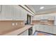Bright kitchen featuring white cabinetry, stainless steel appliances, and warm countertops at 4120 Chelsea Ln, Lakeland, FL 33809