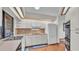 Bright kitchen featuring white cabinets, laminate wood floors, and stainless steel appliances at 4120 Chelsea Ln, Lakeland, FL 33809